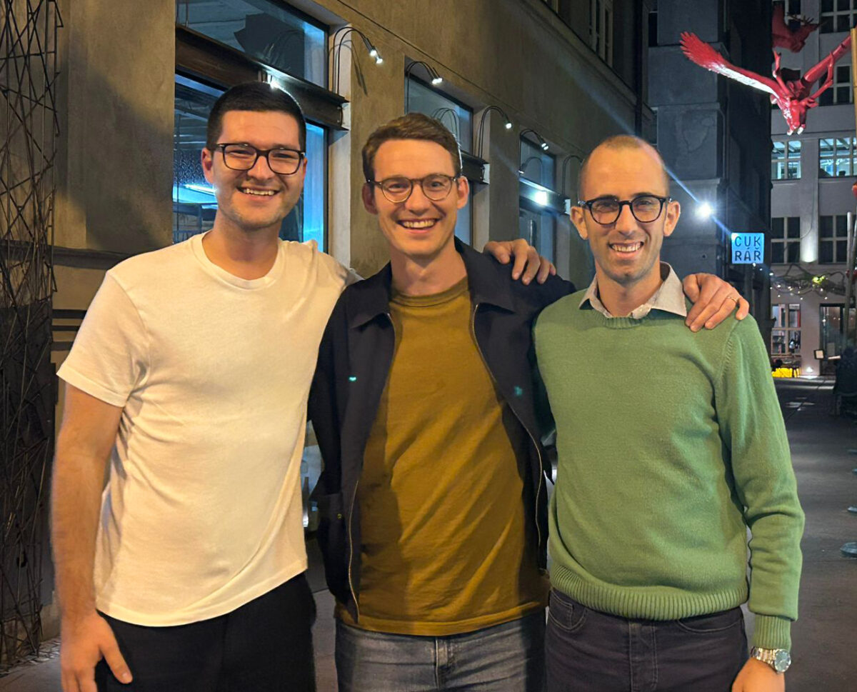 Three young urologists standing next to each other with their hands on each other's shoulders